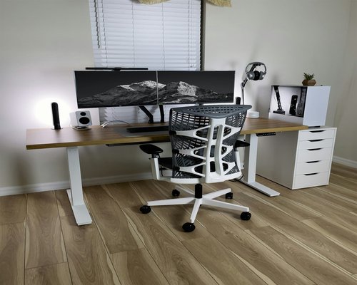 Clean minimalist desk setup with ergonomic chair and dual monitors