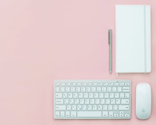Close-up of an organized desk surface with minimal items around the keyboard and mouse